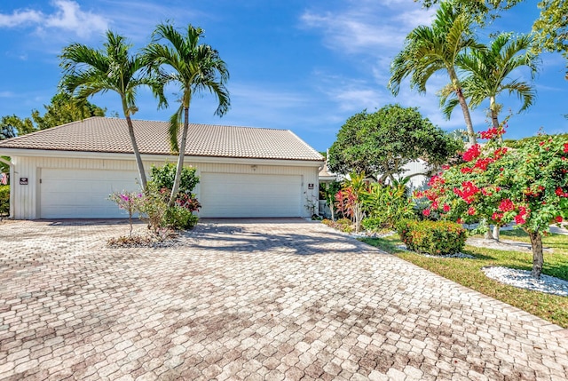 view of front of home with a tiled roof and decorative driveway