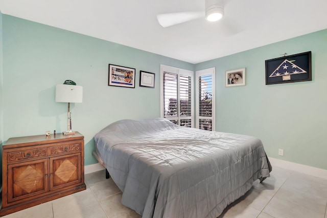 bedroom with light tile patterned floors, baseboards, and ceiling fan