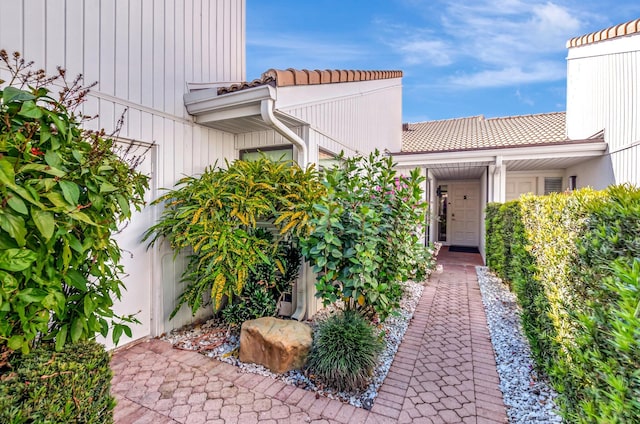 property entrance featuring a tiled roof