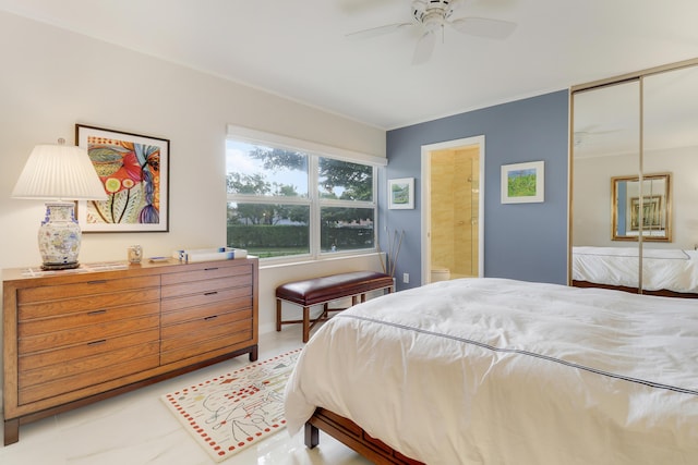 bedroom with a closet, ceiling fan, and ensuite bathroom