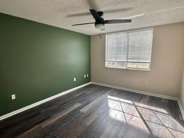 7896 Sonoma Springs Cir Unit 204, Lake Worth, FL 33463 - spare room with baseboards, a textured ceiling, ceiling fan, and dark wood-style flooring