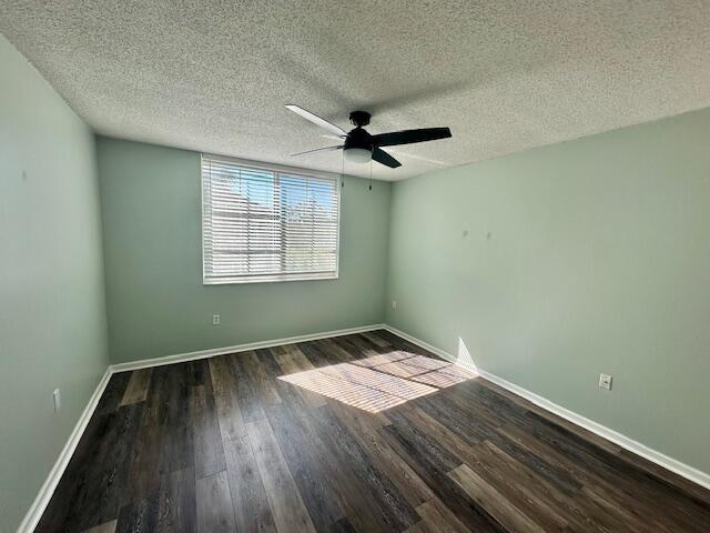 7896 Sonoma Springs Cir Unit 204, Lake Worth, FL 33463 - empty room featuring a textured ceiling, wood finished floors, baseboards, and ceiling fan