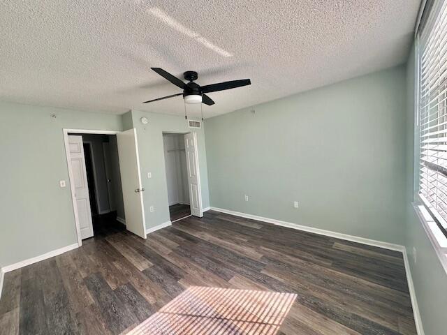 7896 Sonoma Springs Cir Unit 204, Lake Worth, FL 33463 - unfurnished bedroom featuring visible vents, a textured ceiling, dark wood finished floors, baseboards, and ceiling fan