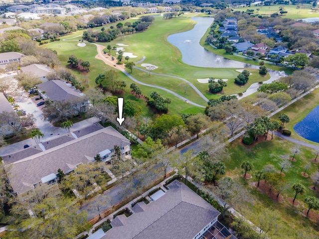 birds eye view of property featuring golf course view and a water view