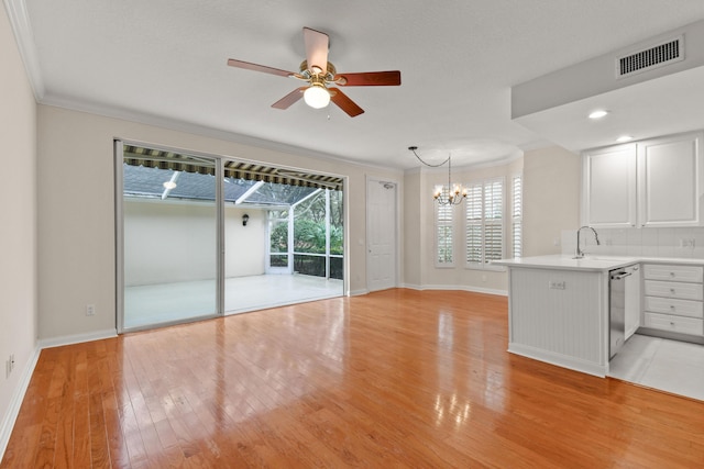 114 Radcliffe Ct, Jupiter, FL 33458 - unfurnished living room featuring ornamental molding, baseboards, ceiling fan, light wood-type flooring, and a chandelier