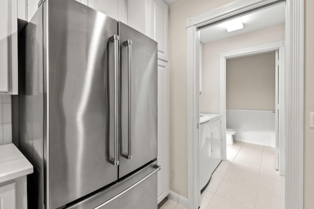 114 Radcliffe Ct, Jupiter, FL 33458 - kitchen with high quality fridge, independent washer and dryer, white cabinets, light countertops, and light tile patterned flooring