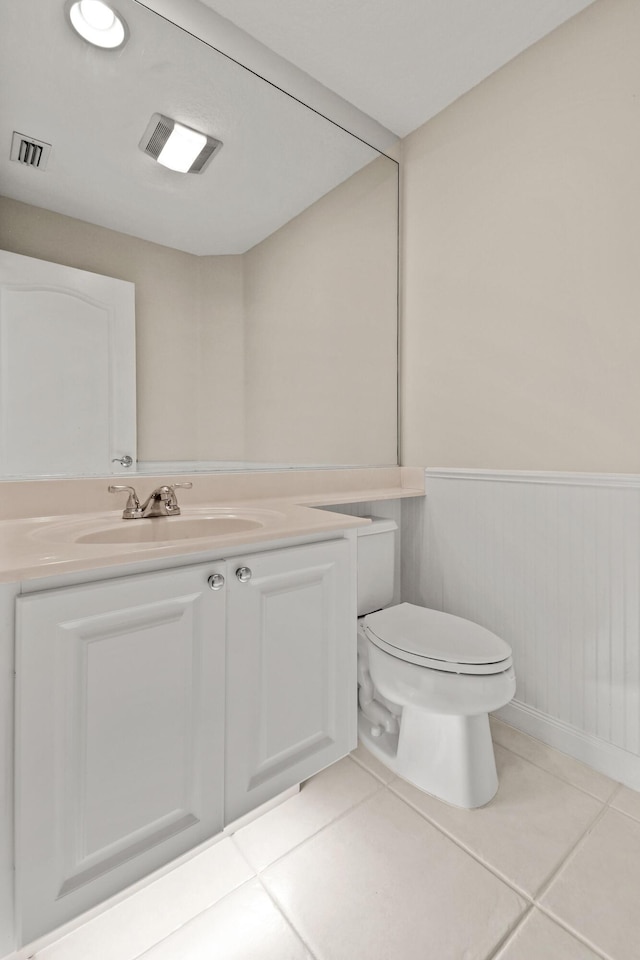 114 Radcliffe Ct, Jupiter, FL 33458 - bathroom featuring toilet, tile patterned flooring, wainscoting, and vanity