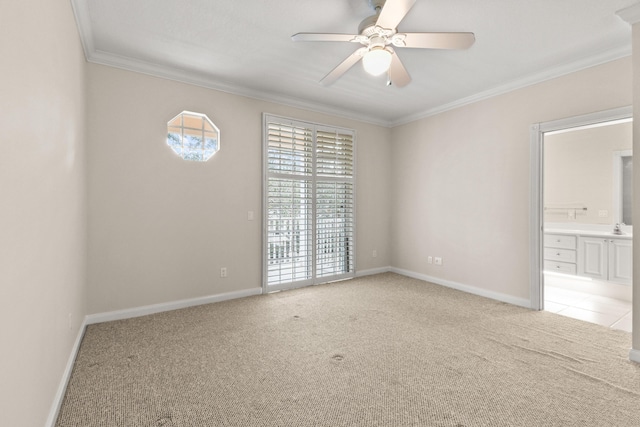 empty room with baseboards, ceiling fan, light colored carpet, ornamental molding, and a sink