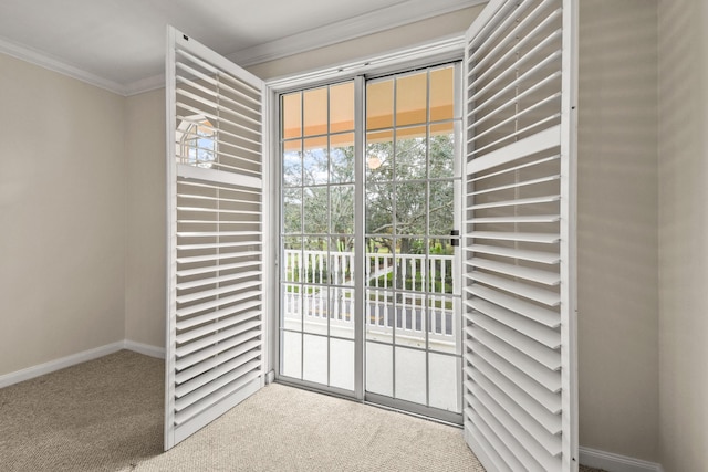 doorway with baseboards, carpet, and ornamental molding