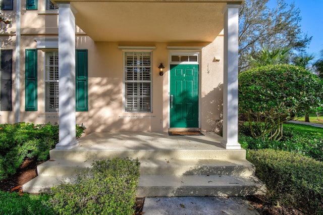 entrance to property featuring stucco siding