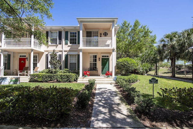 114 Radcliffe Ct, Jupiter, FL 33458 - view of front of house featuring a balcony, stucco siding, and a front lawn