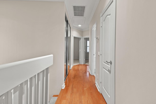 hall featuring visible vents, crown molding, attic access, recessed lighting, and light wood-style floors