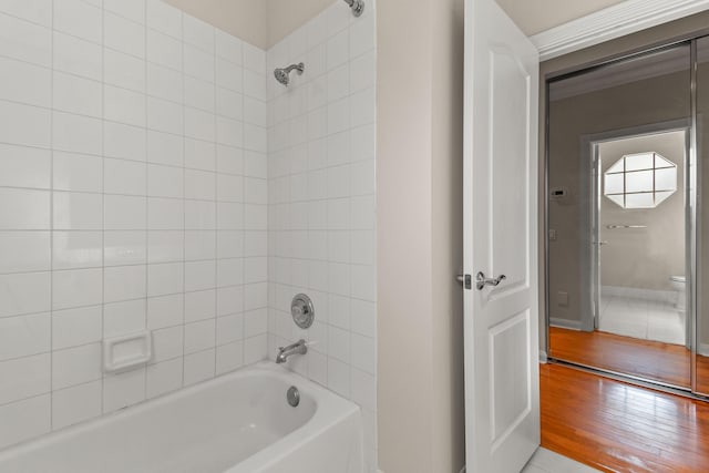 full bath with bathtub / shower combination and wood finished floors