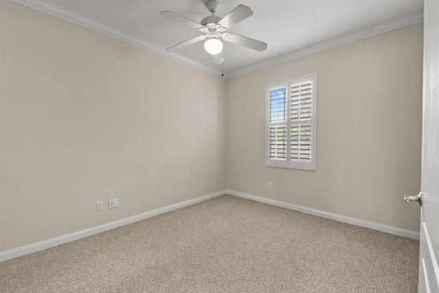 spare room featuring crown molding, carpet floors, and ceiling fan