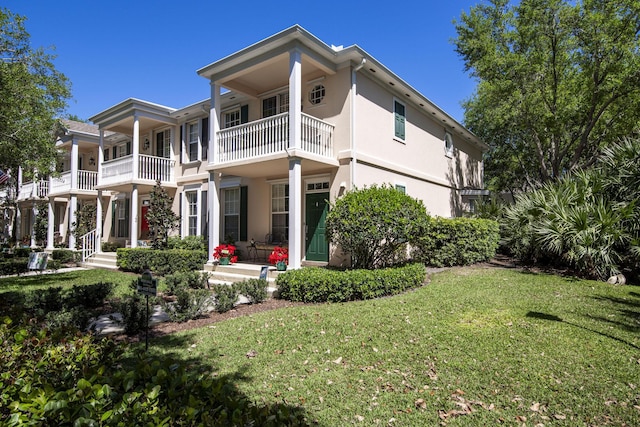 114 Radcliffe Ct, Jupiter, FL 33458 - back of house featuring a yard, stucco siding, and a balcony