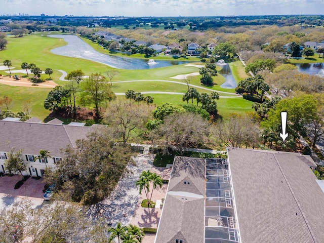 drone / aerial view with view of golf course and a water view