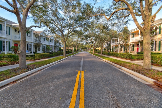 view of street with a residential view, curbs, and sidewalks