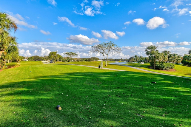 view of home's community featuring golf course view and a yard