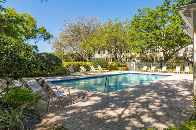 pool featuring a patio area and fence