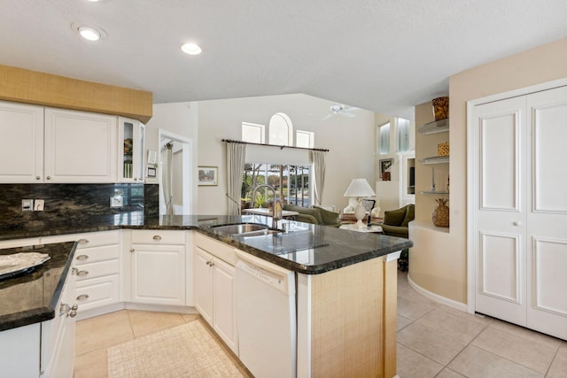 kitchen with ceiling fan, a peninsula, white dishwasher, light tile patterned flooring, and a sink