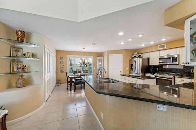 kitchen featuring light tile patterned floors, visible vents, a sink, appliances with stainless steel finishes, and a chandelier