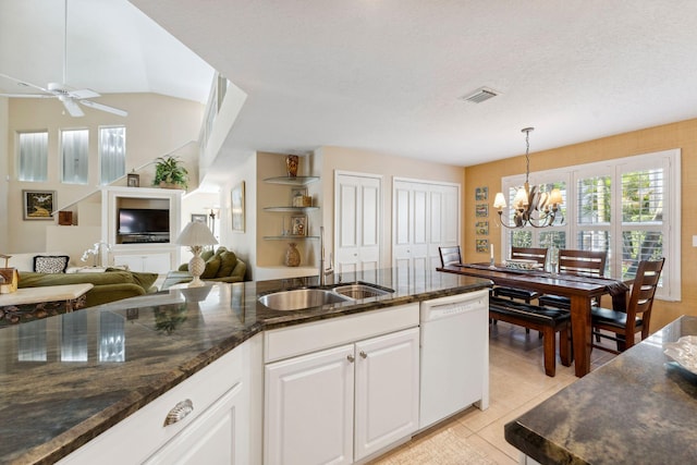 kitchen featuring visible vents, ceiling fan with notable chandelier, white cabinets, light tile patterned flooring, and white dishwasher