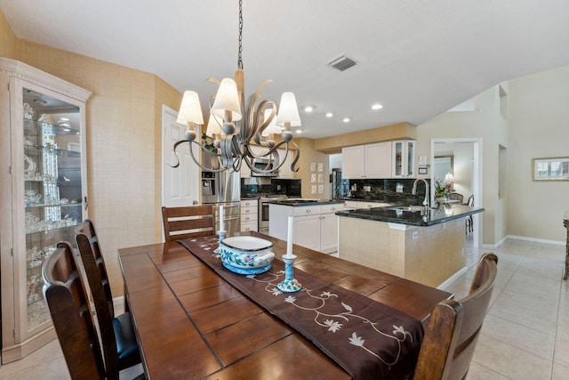 dining space with light tile patterned floors, visible vents, a notable chandelier, and recessed lighting