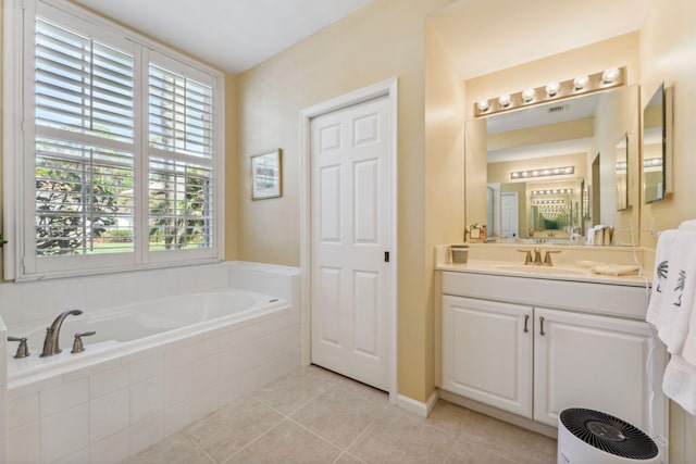 bathroom featuring tile patterned flooring, vanity, and a garden tub