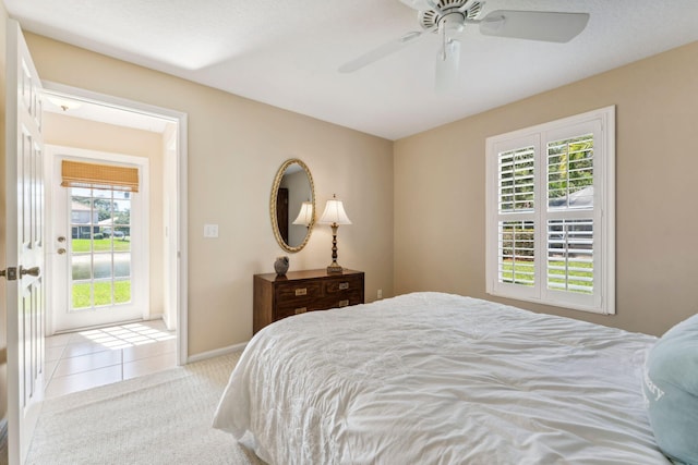 carpeted bedroom with baseboards, ceiling fan, and tile patterned flooring