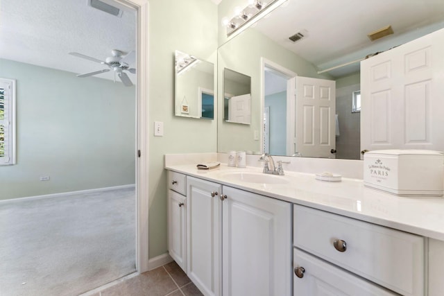 bathroom featuring tile patterned flooring, visible vents, and a ceiling fan