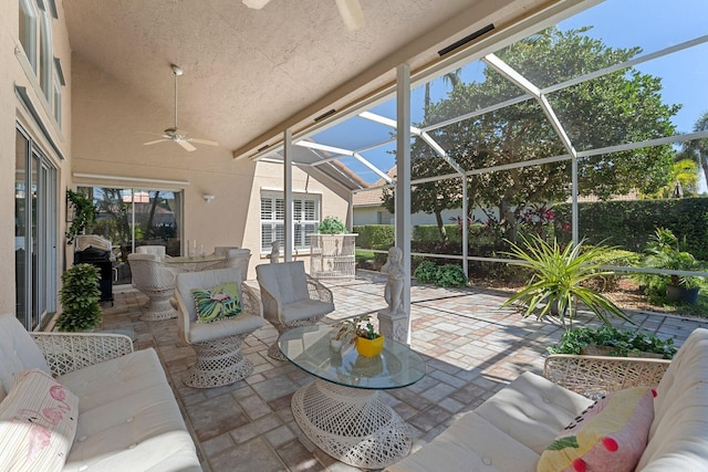 view of patio with glass enclosure, a grill, ceiling fan, and outdoor lounge area