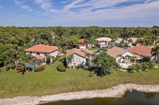 bird's eye view featuring a forest view, a residential view, and a water view