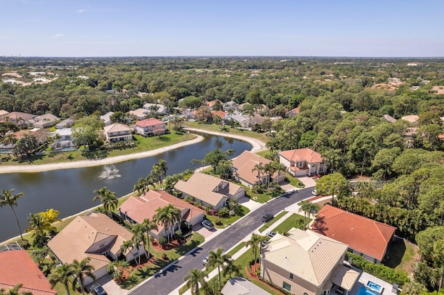 birds eye view of property with a forest view, a residential view, and a water view