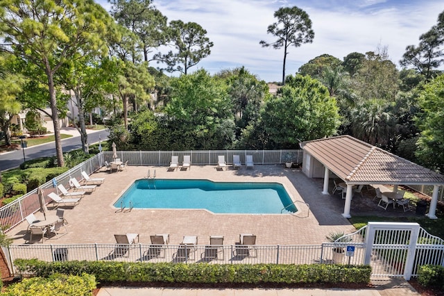 pool featuring a patio area and fence