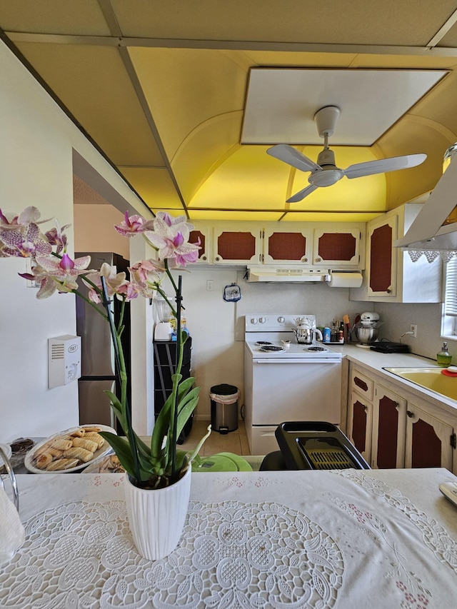 kitchen with ceiling fan, under cabinet range hood, light countertops, electric stove, and a sink