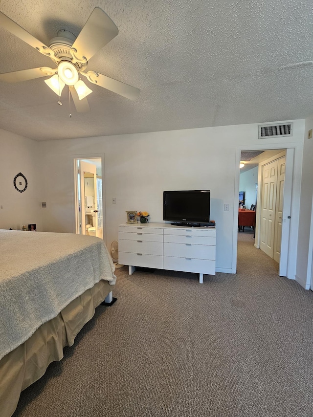 carpeted bedroom with visible vents, a textured ceiling, and ceiling fan