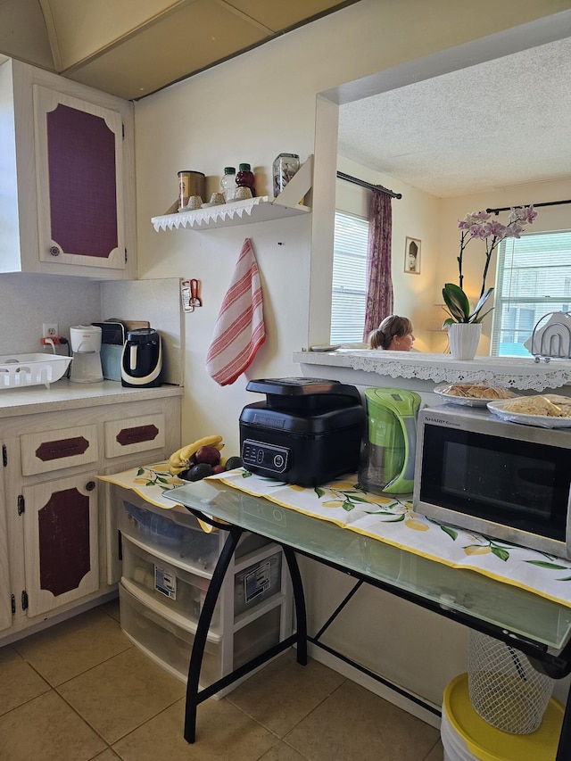 kitchen featuring light tile patterned floors, plenty of natural light, and light countertops