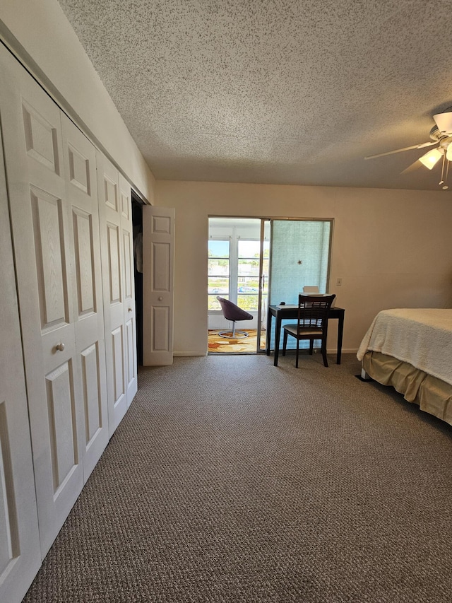 carpeted bedroom featuring a closet, ceiling fan, a textured ceiling, and baseboards