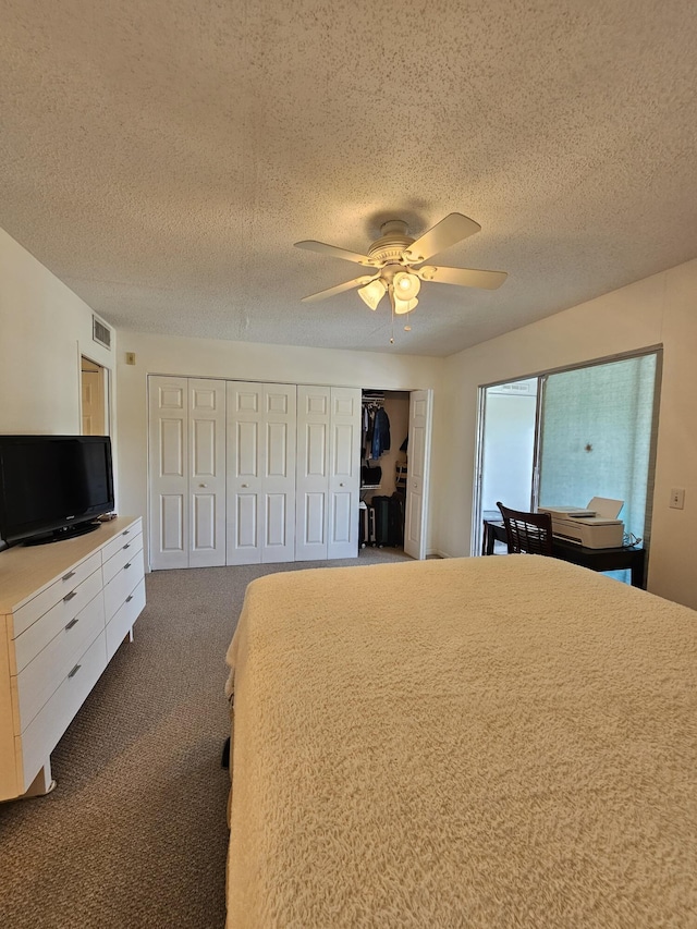 unfurnished bedroom with visible vents, two closets, a ceiling fan, a textured ceiling, and carpet floors