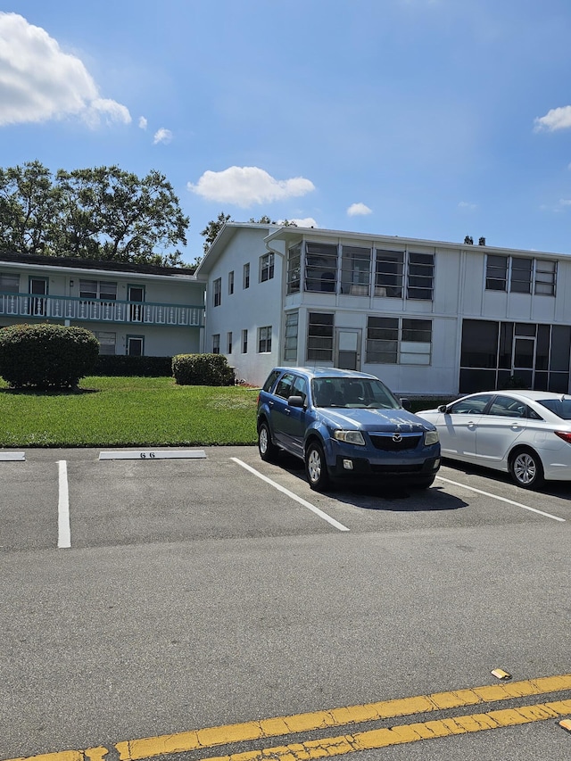 view of property with uncovered parking