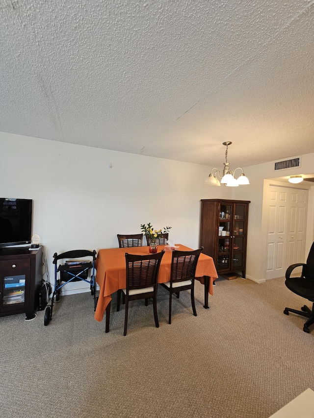 carpeted dining area featuring a chandelier, visible vents, and a textured ceiling