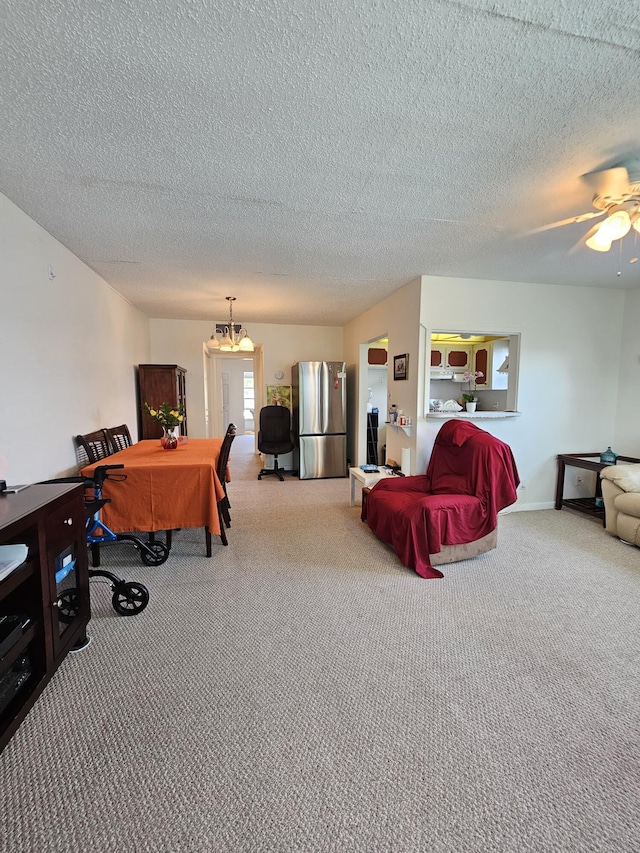 interior space with a ceiling fan, carpet, and a textured ceiling