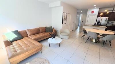 living room with light tile patterned floors and recessed lighting