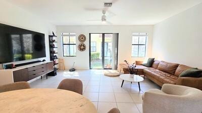 tiled living room with ceiling fan