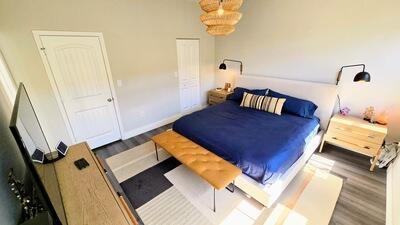 bedroom featuring wood finished floors and baseboards