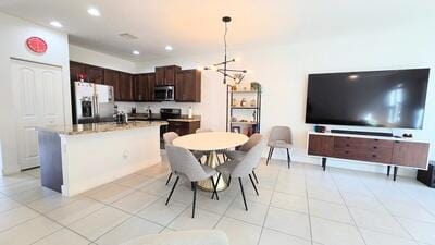 dining area featuring light tile patterned flooring and recessed lighting