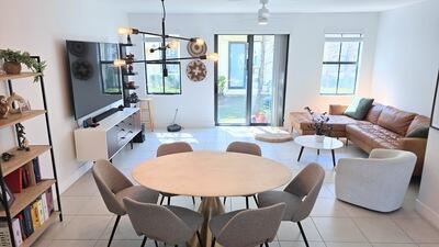 dining space featuring light tile patterned floors and an inviting chandelier