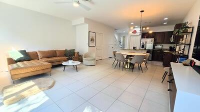 living room featuring light tile patterned floors, a ceiling fan, and recessed lighting