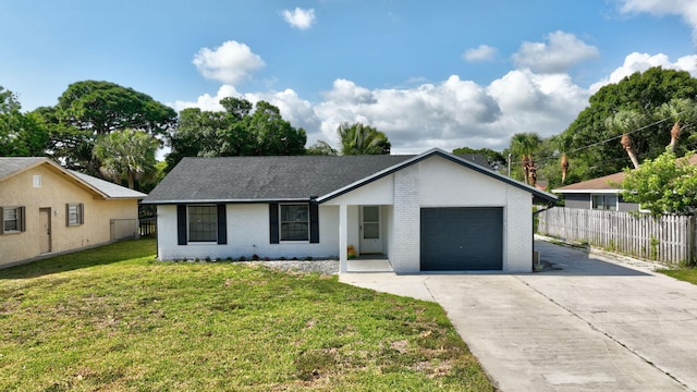 view of front facade with a garage, a front lawn, fence, brick siding, and driveway