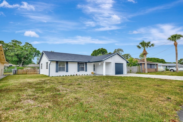 ranch-style house featuring fence, an attached garage, driveway, and a front yard